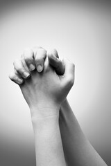 Praying hand sign, two woman's palm are clasped all together, isolated on white. Black and white tone. hand language concept