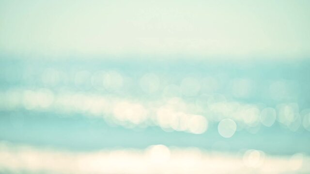 Abstract bokeh background from summer blue sea water at the beach