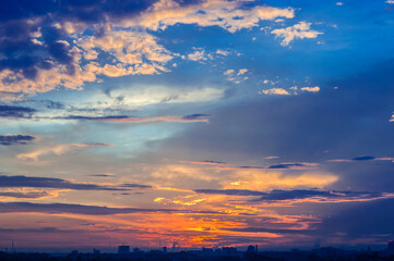 evening city landscape. silhouettes of buildings against a cloudy sky. bright colors panorama