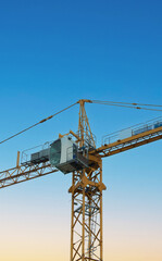Fototapeta na wymiar Construction crane on the isolated background of the sky