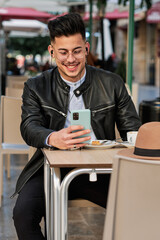 boy talking on the phone having breakfast in a cafeteria