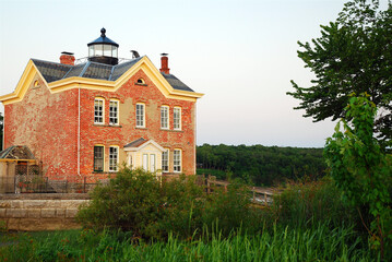 Fototapeta na wymiar The Saugerties Lighthouse once guided ships on the Hudson River now doubles as a bed and breakfast