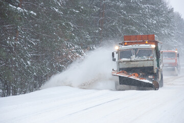 Snowblowers work on a winter road