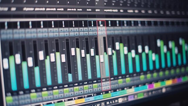 Detail of monitor with multitrack music software mixer with automatically changing volumes. Close-up panning