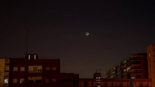 Time-lapse of the moonset behind some buildings in the city of Barcelona.