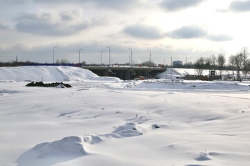 Fototapeta na wymiar Landscape with a road bridge under construction in winter.