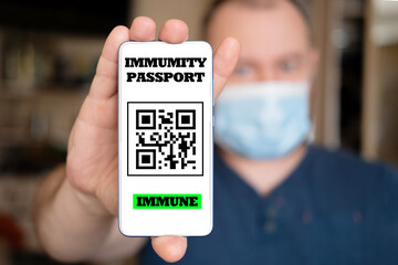 Passport immunity. A male hand holds a phone with a digital application.