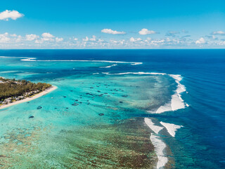Naklejka na ściany i meble One eye beach in Mauritius. Underwater waterfall and waves in ocean. Aerial view of Le Morne
