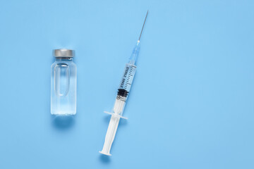 Virus protection vaccine, prevention concept, diabetes injection. A medical bottle with a clear liquid and a plastic medical syringe with a removable needle. Vaccination against coronavirus COVID-19. 
