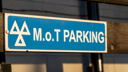 Close up of an MOT parking sign at a garage - obrazy, fototapety, plakaty