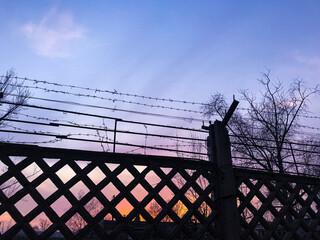 barbed wire fence against sky