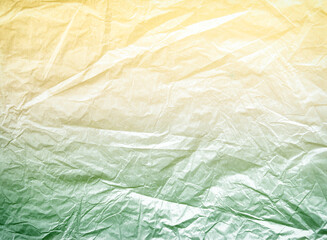Worn, old, crumpled paper. The background for the texture looks like crumpled parchment in yellow and green tones