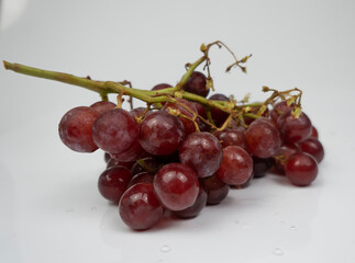Fresh red grapes isolated on white background. Selective focus on the fresh red grapes.