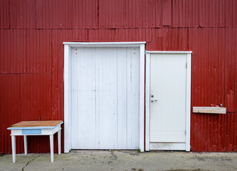 Obraz na płótnie Canvas white wooden door of a red painted scandinavian building