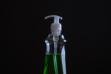 Isolated hand sanitizer on a black background. Close-up.