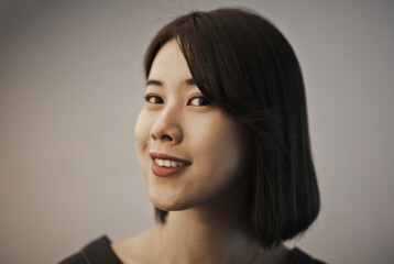 Fototapeta premium portrait of smiling young asian woman