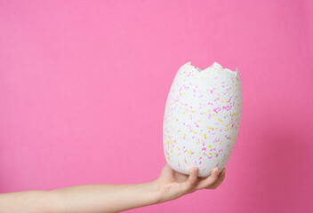 Hand holding broken egg, Easter concept, greeting card