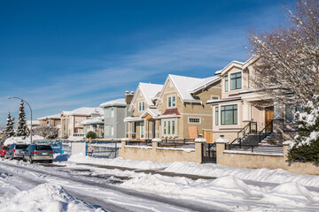 Street of brand new luxury houses on blue sky background in winter