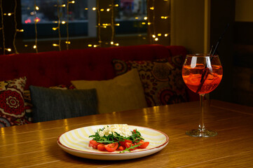 Spring vegetable salad with tomatoes on white plate