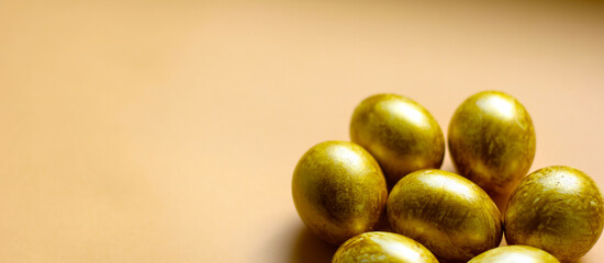 Easter background with golden eggs on light yellow background. Template for poster, advertisement, poster, postcard. Happy Easter background top view, copy space. Banner size