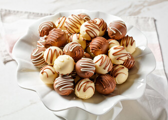 Chocolate truffles balls on a white platter