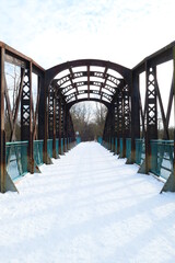Old military bridge over the river in winter