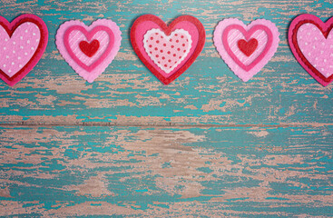 Simple Background with Felt Love Hearts on a Wood Table