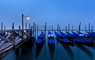 Gondolas tied up at San Marco with San Giorggio Maggiore in the distance, Venice, Veneto, Italy