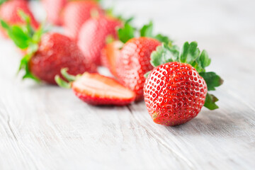 Juicy fresh strawberries on old white wooden background.