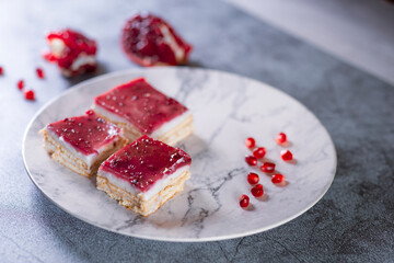 Top view of pomegranate dessert over grey stone backdrop