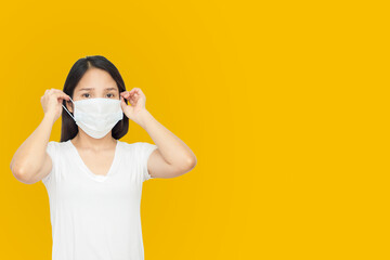 Asian women wear face mask to preventive covid'19 pandemic in orange background