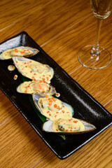 Oysters with red caviar on wooden background