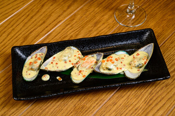 Oysters with red caviar on wooden background
