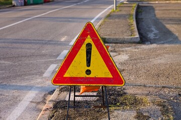 A triangular road sign with an exclamation point indicating work in progress (Marche, Italy, Europe)