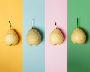 Pastel colored background concept with fresh pears. Fresh pear pattern on a colorful background, top view. The combination of a fresh pear look with an attractive wallpaper. fresh fruits Wallpaper.