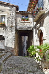 A narrow street between the stone houses of Morcone, an old town in the province of Benevento, Italy.
