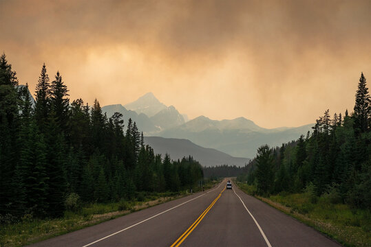 Dramatic landscape with smoke clouds along a highway in British Columbia during wildfires, Canada.