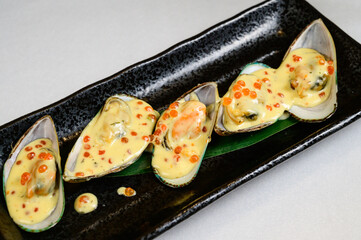Oysters with red caviar on white background