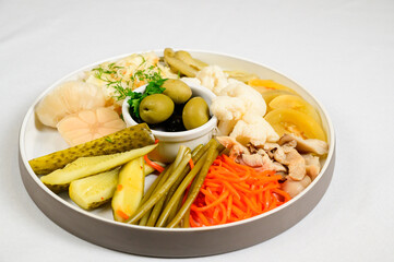Different types of pickled vegetables on white background