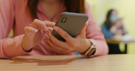 Woman use of mobile phone in restaurant