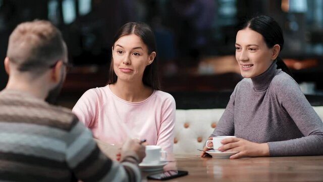 Group friendly people talking at informal meeting shaking hands in public cafe. 4k Dragon RED camera