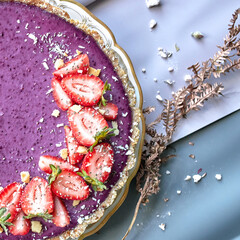 Delicious cheesecake with blueberries with strawberry, close-up.