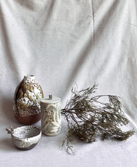 Various ceramic vases and winter dry flowers . Dry flowers bouquet. Winter, autumn ,ceramic floral decor herbarium for home working space.