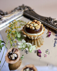 small cake with hazelnuts and macadamia nuts. Nut tart with caramel.