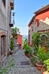 A narrow street between the stone houses of Morcone, an old town in the province of Benevento, Italy.

