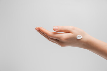 Woman applying hand cream  for hands.