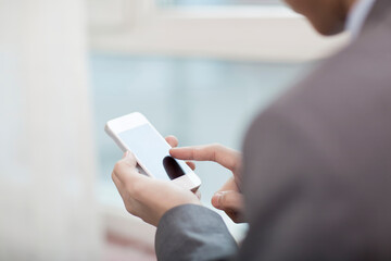 Portrait of young bisinessman using cell phone