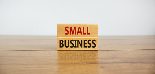 Small business symbol. Wooden blocks form the words 'small business' on beautiful wooden table,...