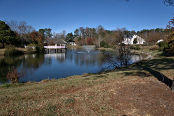 Fototapeta premium Fountain in a lake with a gazebo in the background