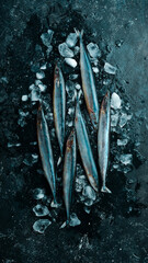 Raw fish saira on ice on a black stone background. Seafood. On a dark background.